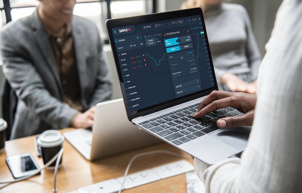 A person using a crypto trading dashboard on a laptop