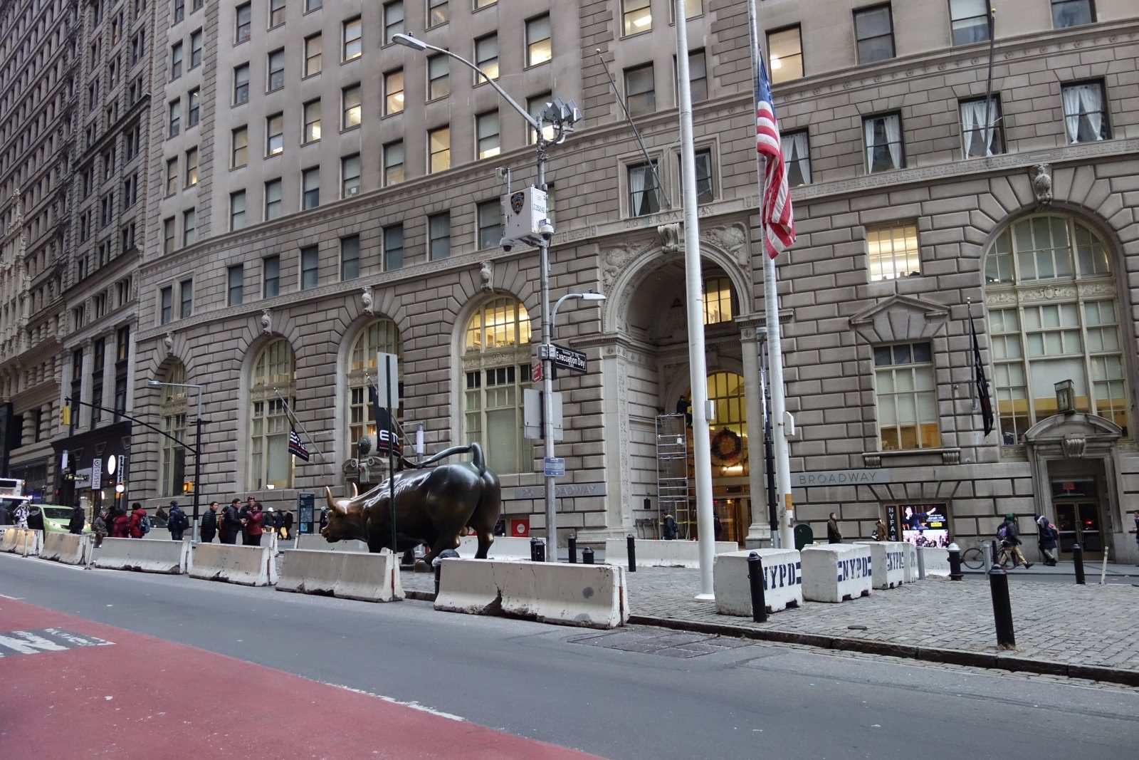 Broad Street in New York's financial district with the bull statue in the distance