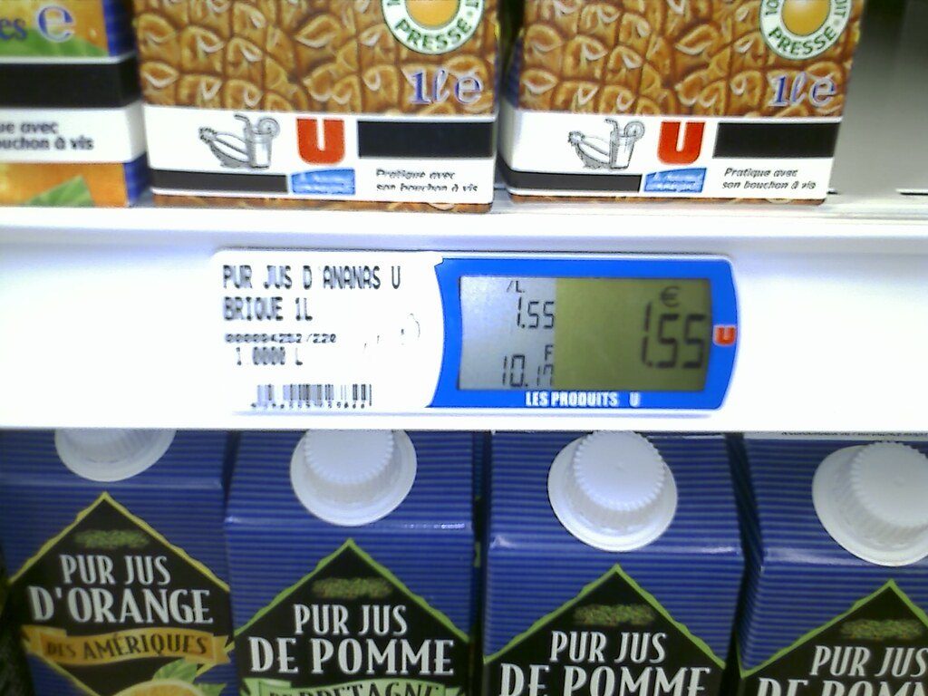 Electronic shelf price labels above cartons of juice
