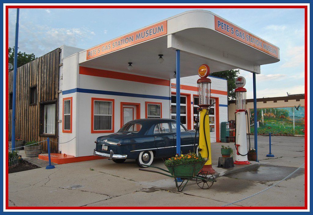 A restored vintage petrol station with an old car at the pump
