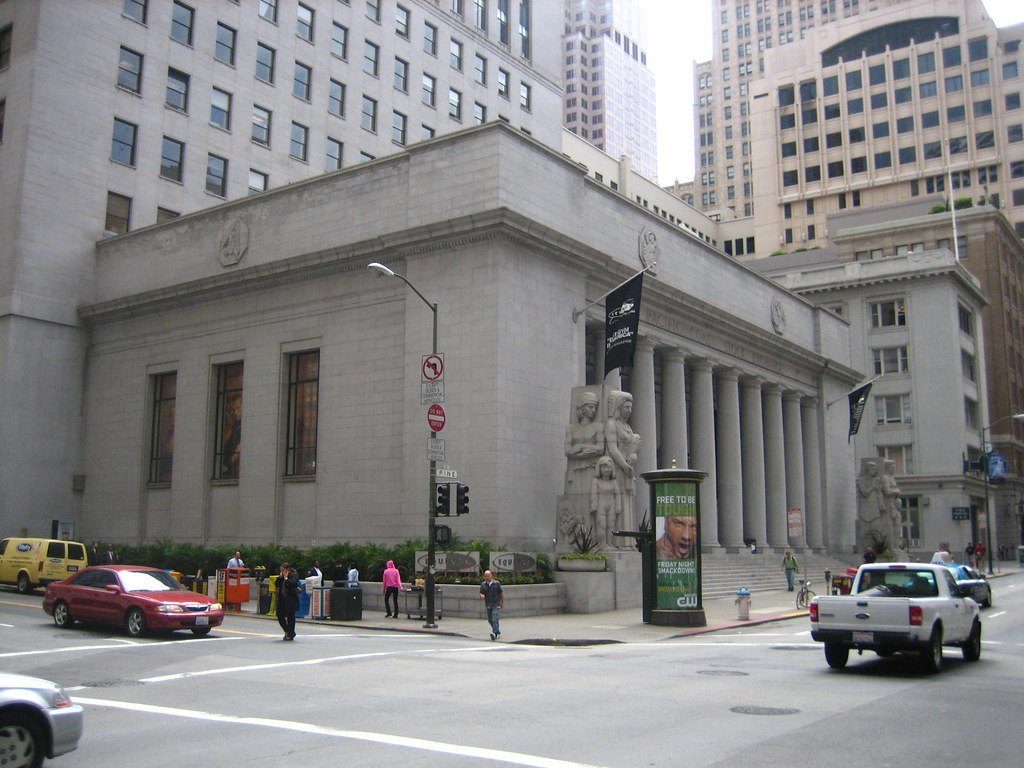 A classical stone bank building on a city street corner