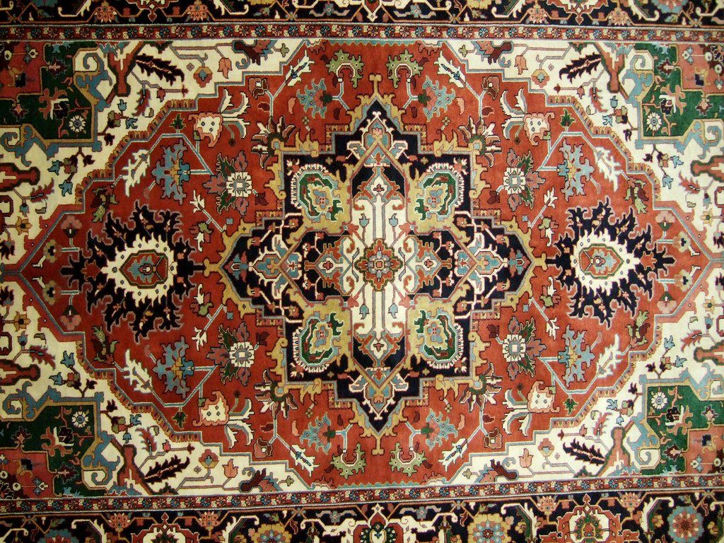 A patterned red rug viewed from above